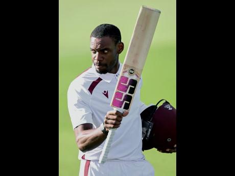 West Indies’ Justin Greaves raises his bat while celebrating scoring 200 runs against New Zealand on day five of their cricket Test match in Christchurch, New Zealand on Saturday.