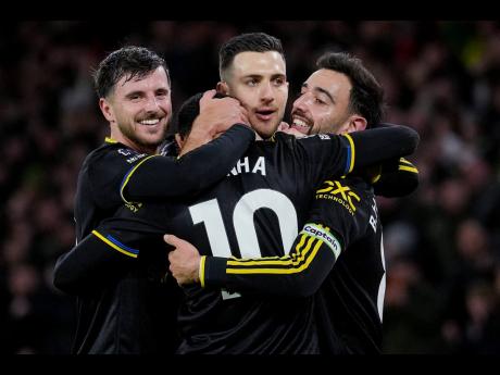Credit: AP Manchester United players celebrate after a goal during the English Premier League soccer match against Wolverhampton Wanderers in Wolverhampton, England, yesterday. Manchester United won 4-1.
