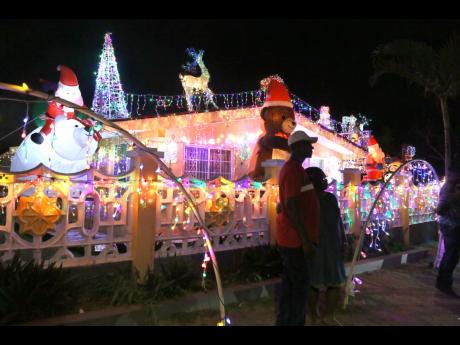 Credit: File For decades, visitors gather nightly along Fairbanks Drive in Mandeville, Manchester, drawn by the glittering Christmas lights and the chance to capture memories with friends and family.