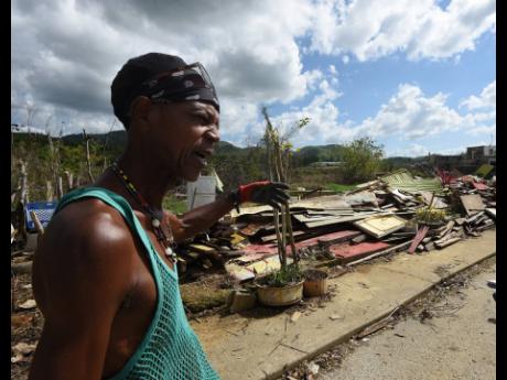 Credit: Ian Allen/Photographer Kenneth Hanson gestures toward what remains of his shop in New Market, St Elizabeth, more than a month after Hurricane Melissa tore through the area.
