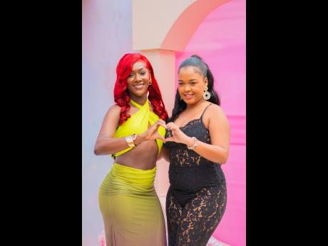 Nisa Wynter (left), image analyst, and Daedria Palmer, digital marketer, shoot a playful pose for our lens. 