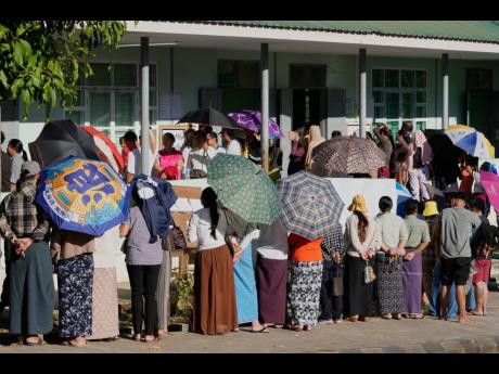 Voters line up to cast their ballots at a polling station, in Naypyitaw, Myanmar, on Sunday.
