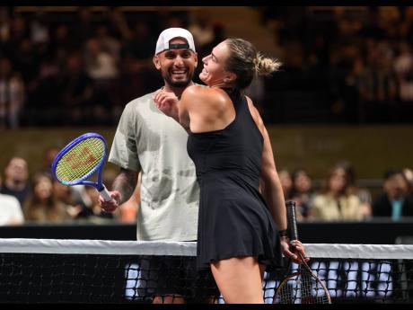 Nick Kyrgios (left) and Aryna Sabalenka interact at the net during their Battle of the Sexes tennis match, in Dubai, United Arab Emirates, on Sunday.