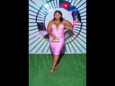 Credit: Contributed Customer care agent Temola Thompson is daringly hot in a deep plunged, curve-hugging dress.