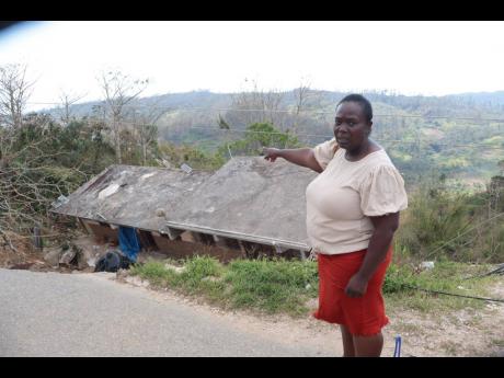 Teacher and businesswoman, Joan Montaque, gestures toward the remains of one of her properties in Litchfield, Trelawny, which collapsed during Hurricane Melissa on October 28.

