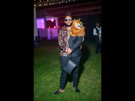 Jovanni Lancaster commands attention like the king of the jungle in a bold custom Kahee Fashions ensemble, complete with leopard-print accents and a lion’s mane detail.