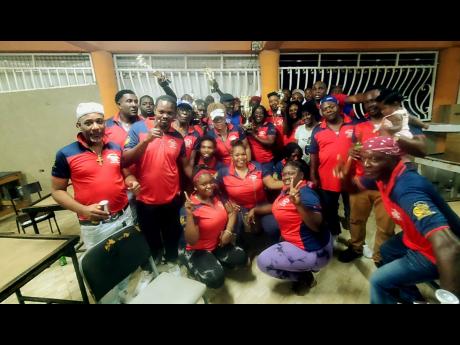 Credit: Contributed Members of Bull Bay United celebrate after their victory over Links in the Domino Association of Jamaica Limited final, held at Cookies Club in Portmore, St Catherine.