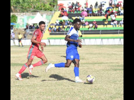 Mount Pleasant Academy’s Kyle Ming (right) tries to outrun Montego Bay United’s Timar Lewis during their Jamaica Premier League game at Jarrett Park on Sunday, December 28, 2025.