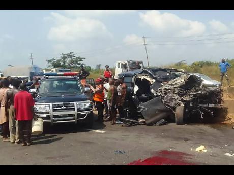 Credit: Uncredited In this photo provided by the Federal Road Safety Corps, people gather at the accident scene of British boxer Anthony Joshua in Lagos, Nigeria, on Monday.