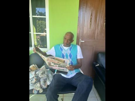 Credit: Contributed Algon Johnson reading a copy of THE STAR.