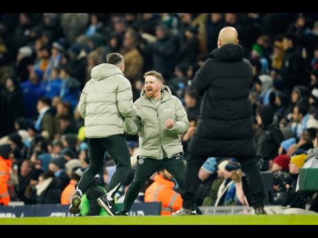 Chelsea’s head coach Calum McFarlane (centre) celebrates after Enzo Fernandez scored during the English Premier League soccer match against Manchester City in Manchester, England, on Sunday. The game ended 1-1.