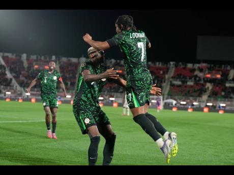 Nigeria's Victor Osimhen (centre) celebrates with Ademola Lookman after scoring his team's third goal during their Africa Cup of Nations football match against Mozambique in Fez, Morocco, on Monday.