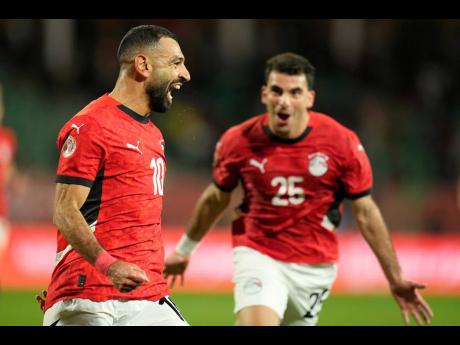 Egypt’s Mohamed Salah (left) celebrates after scoring his team’s third goal against Benin during their Africa Cup of Nations round-of-16 football game in Agadir, Morocco, on Monday. Egypt won 3-1.