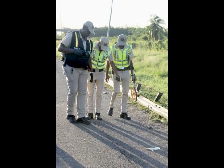 Credit: Nathaniel Stewart Crash investigators on a scene late last year.