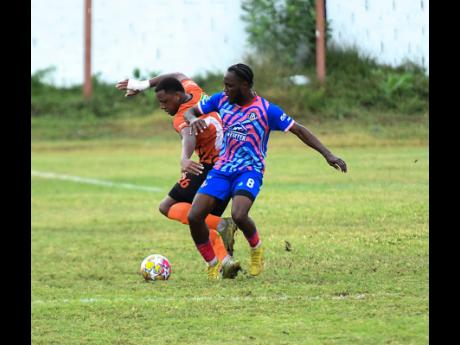 Credit: Antoine Lodge Akeil Leachman of Tivoli Gardens FC (left) battles for the ball with Akeem Mullings of Portmore United FC during the Jamaica Premier League football match at Edward Seaga Sports Complex in Kingston. The game ended 2-2.