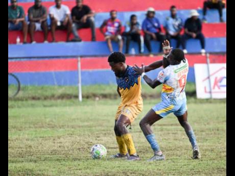 Racing United’s Marcovich Brown shields the ball from Waterhouse’s Javane Bryan during their Jamaica Premier League match at Ferdi Neita Park on Sunday, January 4, 2026.