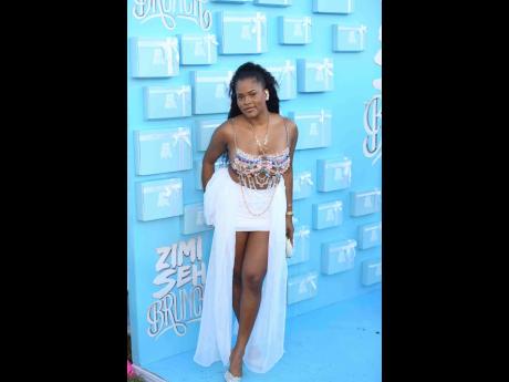 Ronique Johnson, an accountant, delivered a refined take on daytime glamour in a flowing, white miniskirt ensemble from Kadian Exclusive, layered with metallic detailing and soft movement.