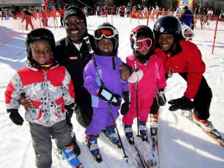 In this undated handout photo provided by Karen Rivers, dad Henri Rivers and mom Karen Rivers pose with children Henniyah, Henri IV and Helaina in Windham Mountain, New York. 