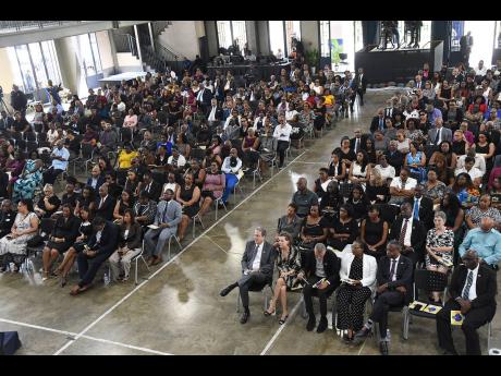Mourners are gathered inside the Karl Hendrickson Auditorium at Jamaica College to pay tribute to the late Anthony Smith.