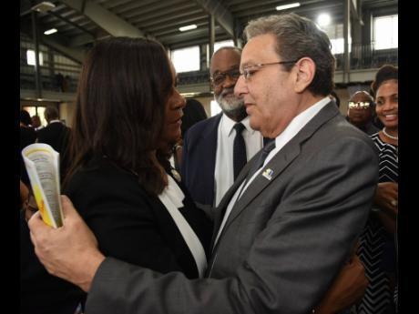 Joseph M. Matalon (right), executive chairman of the RJRGLEANER Communications Group, offers condolences to Karen Smith (left), widow of the late Anthony Smith.