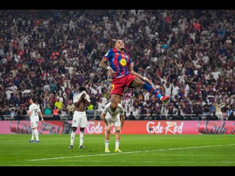 Barcelona’s Raphinha celebrates after scoring his second goal during the Spanish Super Cup final  against Real Madrid at King Abdullah Sports City Stadium in Jeddah, Saudi Arabia, yesterday.