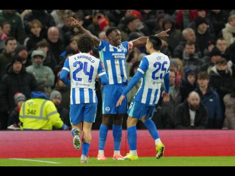 Brighton’s Danny Welbeck (centre) celebrates after scoring during the FA Cup third-round match between Manchester United and Brighton in Manchester, England, yesterday.