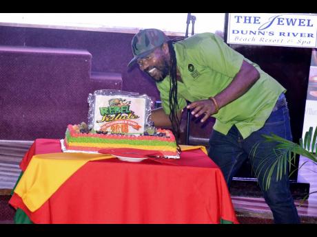 Tony Rebel poses with his birthday cake that was presented by Jewel Dunn’s River Beach Resort and Spa as he held Rebel Salute 2018. With this year’s staging set for overseas, Rebel is set to have a quiet birthday. 