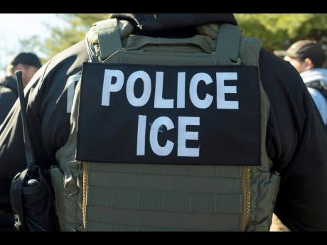 FILE - A U.S. Immigration and Customs Enforcement officer listens during a briefing, Jan. 27, 2025, in Silver Spring, Md. (AP Photo/Alex Brandon, File)