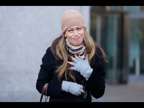 Former record company exec, Drew Dixon, talks to a fan before entering the courthouse in New York, Monday. Her sexual assual case against L. A. Reid was settled on Monday.
