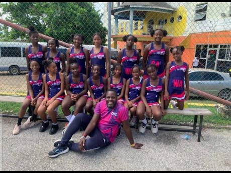 Credit: Contributed Corinaldi Avenue Primary netball coach Omroy Kerr (front) poses with his team after a recent match. Corinaldi are the defending netball and football champions of the Insports St James Primary schools competitions.