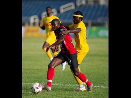 Arnett Gardens’ Fabian Reid (centre).
