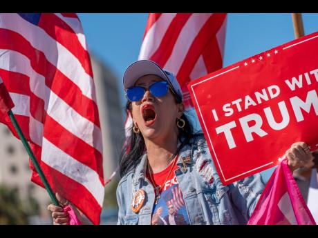 Maribel Gonzalez celebrates outside Versailles Cuban Cuisine after President Donald Trump announced President Nicolás Maduro had been captured and flown out of Venezuela.