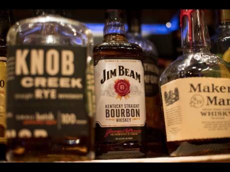 FILE - Jim Beam, Knob Creek and other alcohol bottles are pictured at a bar in Eagle, Colo., Dec. 25, 2018. (AP Photo/Jenny Kane, File)
