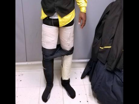 In this 2018 photo, an airways crew member is caught with four packages of cocaine strapped to his legs, highlighting the bold tactics traffickers are using to smuggle drugs.