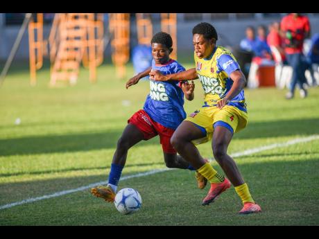 Greg Hamilton (left) of Kemps Hill High fights for possession of the ball with Malachi McMaster of St Elizabeth Technical during their daCosta Cup football semi-final at Sabina Park on Wednesday, December 17, 2025. STETHS won 1-0.