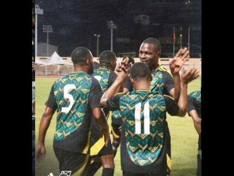 Jamaica’s Reggae Boyz celebrate at the end of yesterday’s friendly against Grenada at the Kirani James Stadium in St George’s Grenada. Jamaica won 1-0.