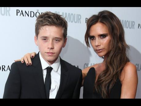 In this Tuesday, June 4, 2013 file photo, Victoria Beckham and son Brooklyn arrive for the Glamour Women of the Year Awards at Berkeley Square Gardens, London. 