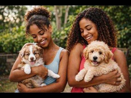 Young Jamaican women enjoy playful moments with their fluffy companions.
