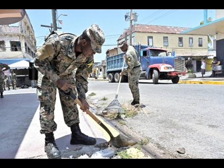 Members of the Jamaica Defence Force carry out work in Parade Gardens during last year’s Labour Day activities.