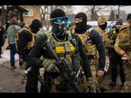 Credit: ap Federal agents stand guard in Minneapolis, Minnesota.