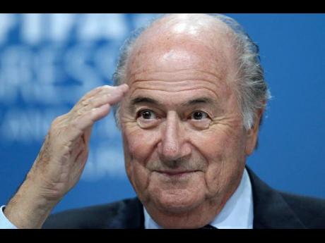 In this June 1, 2011, file photo, Sepp Blatter gestures during a press conference in Zurich, Switzerland. 