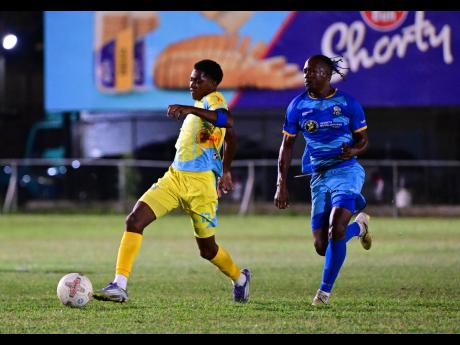 Credit: Gladstone Taylor/Multimedia Photo Editor Ky-Mani Campbell of Waterhouse FC dribbles, while being chased by Tyrique Wilson of Molynes United FC during the Jamaica Premier League match at Waterhouse Mini Stadium in St Andrew on Sunday, December 28, 2025.