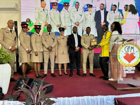 Credit: Contributed Rev Dr Otis Manning, Pastor, presents the St Andrew North Management team with a plaque