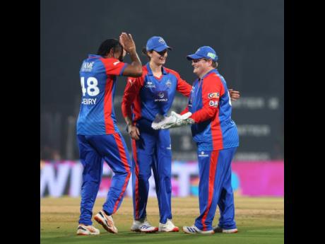 Credit: Courtesy of @WPLT20/IG Delhi Capitals’ Chinelle Henry (left) and wicketkeeper Lizelle Lee (right) celebrate a wicket during a Women’s Premier League T20 cricket match against the Gujarat Giants at the Dr DY Patil Sports Academy on Sunday.