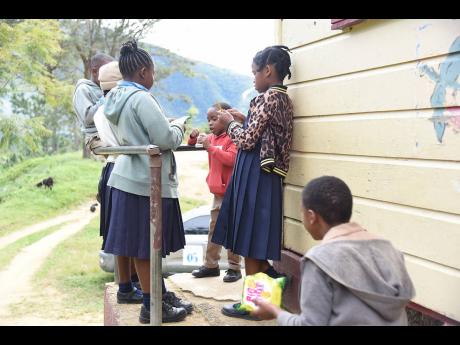 Students take a break from class in the usually cold mountain school.