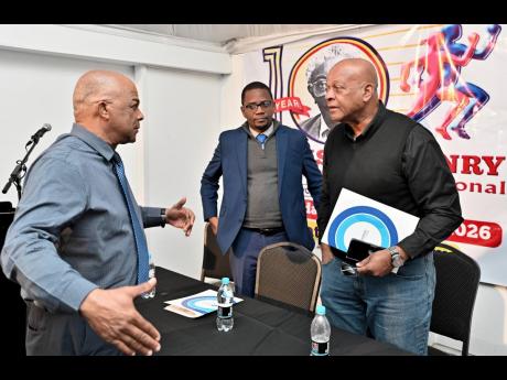 Leroy Cooke (left), chairman of the Local Organising Committee of SW Isaac-Henry Track and Field Invitational meet, chats with Dr Worrell Hibbert (centre), principal of St Andrew Technical High, and Brian Smith, JAAA executive member, at the launch of the SW Isaac-Henry Track and Field Invitational meet at the S Hotel in New Kingston yesterday.