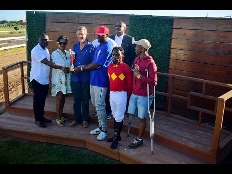 Winning connections of PACK PLAYS, including jockey Christopher Mamdeen (second right) at the presentation of the Eileen Cliggott Memorial Trophy, ran over six-and-a-half furlongs, at Caymanas Park on Saturday.