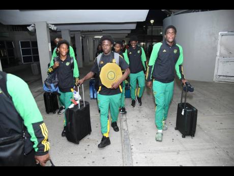 Credit: Antoine Lodge Members of Jamaica’s Under-17 Men’s football team upon arrival at the Norman Manley International Airport last night. The under-17 Reggae Boyz topped the Concacaf U17 Championship Final in Costa Rica and booked their ticket to the FIFA U17 World Cup, which will be held in Qatar in November.