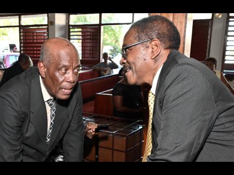Retired Justice Seymour Panton (right), brother of the late Joan Vivene Kelly, chats with Terrence Kelly, her husband, at the service of thanksgiving for her life at Meadowbrook United Church on Flemington Drive in Kingston on Friday.