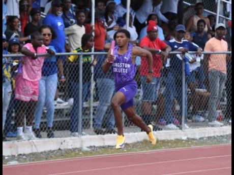 Credit: Antoine Lodge Kingston College’s Kyle Bodden stretches his legs during the Class One 4x100 metres at the Corporate Area Athletics Championships at the Ashenheim Stadium, Jamaica College, on Saturday.